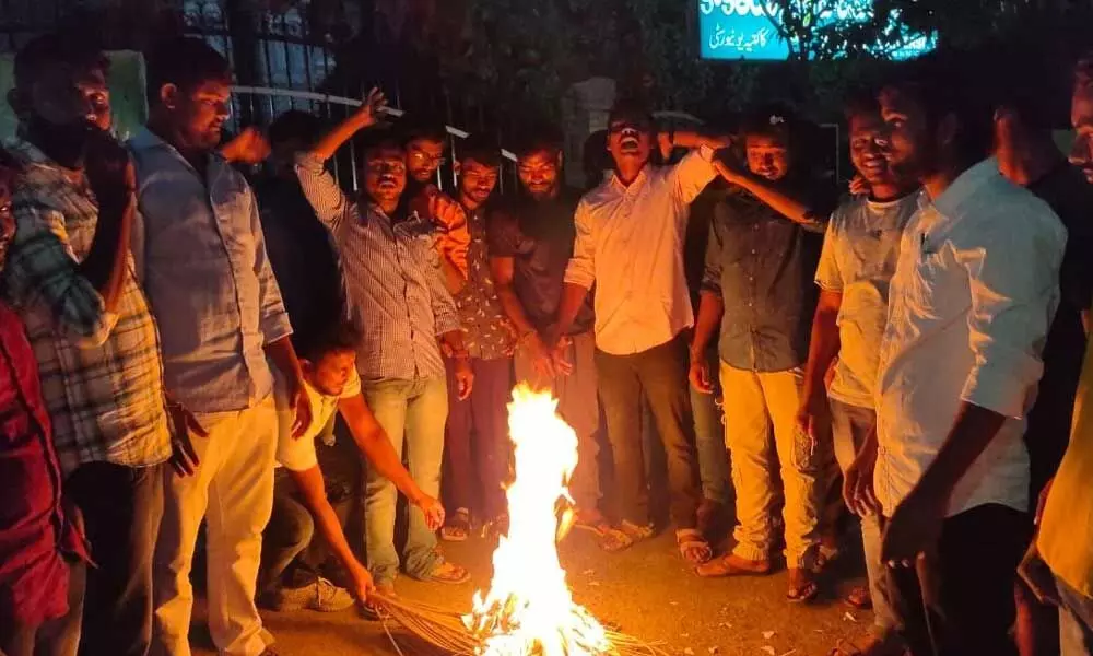 student unions including ABSF, BSF, ASA, SSBMVM and SSF, burned the copies of Manu Smriti near Kakatiya University Gate-I in Warangal on Saturday
