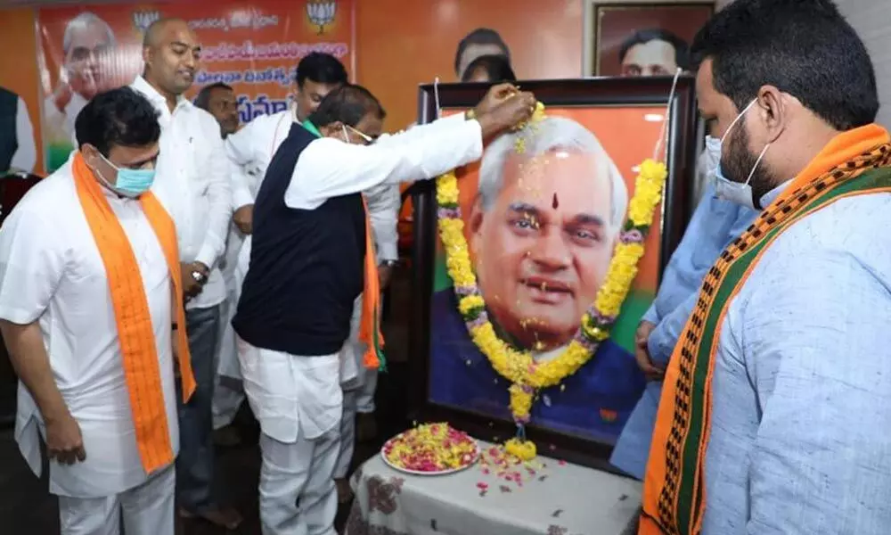 BJP State president Somu Veerraju, party State in-charge Sunil Deodhar and others paying floral tributes to former Prime Minister Atal Bihari Vajpayee at the party office in Vijayawada on Saturday