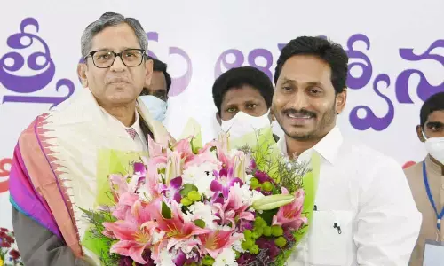 Chief Minister Y S Jagan Mohan Reddy felicitating Chief Justice of India Justice N V Ramana at a ‘High Tea’ hosted by the AP government at the IGMC Stadium in Vijayawada on Saturday