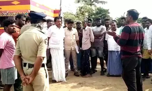 Ayurvedic practitioner B Anandaiah and villagers discuss problems in distribution of his herbal mix at Krishnapatnam on Moday