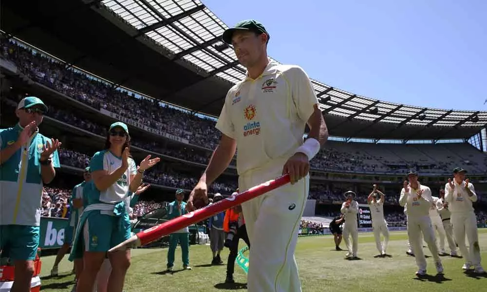Australias Scott Boland holds a stump after taking 6 wickets against England in their win on the third day of the Test match in Melbourne, Australia on Tuesday.