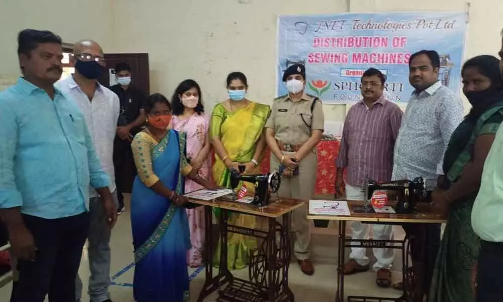 Additional SP Supraja, DRDA PD Tulasi and others distributing sewing machines to women in Tirupati on Wednesday