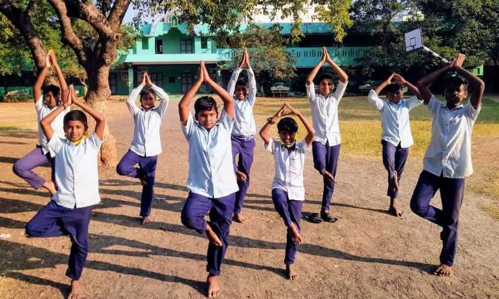 Students performing yoga at a school