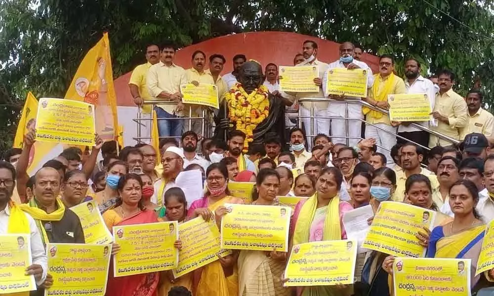 TDP leaders staging a dharna at GVMC Gandhi statue in Visakhapatnam on Wednesday