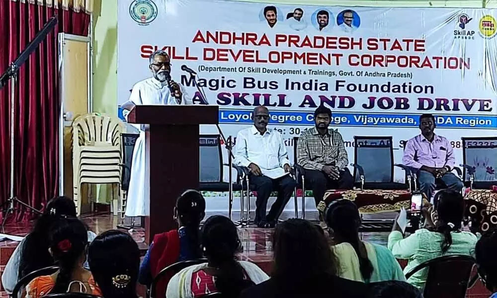 Andhra Loyola College principal Fr GAP Kishore addressing the candidates at a job mela in Vijayawada on Thursday