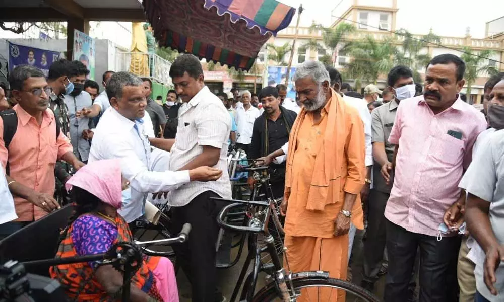 Panchayat Raj Minister P Ramachandra Reddy distributing tricycles in Punganur on Thursday