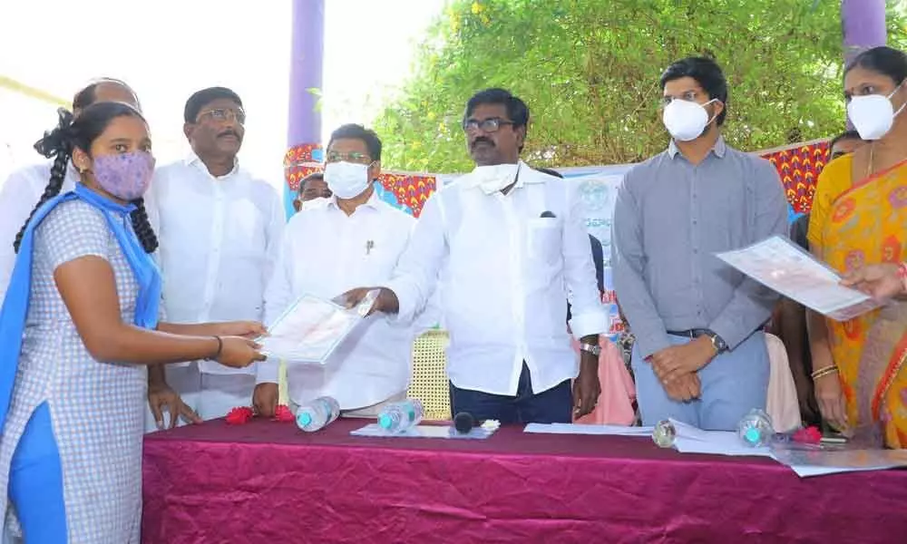 Minister Ajay  Kumar and Collector VP Gautam distributing certificates to the students at school  in Khammam district on Thursday