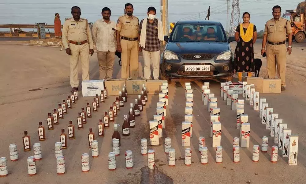 SEB Circle Inspector M Manjula and her staff with seized liquor bottles at Panchalingala border check post on Thursday