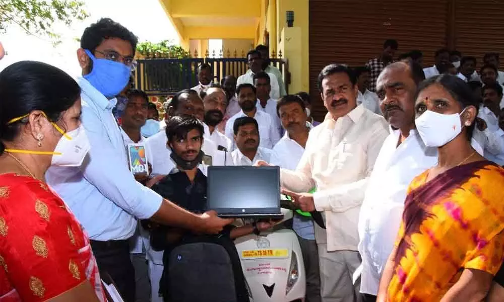 Government Whip Gampa Govardhan, District Collector Jitesh V Patil and ICDS PD Saraswathi distributing four-wheeled two- wheelers to the disabled on Thursday