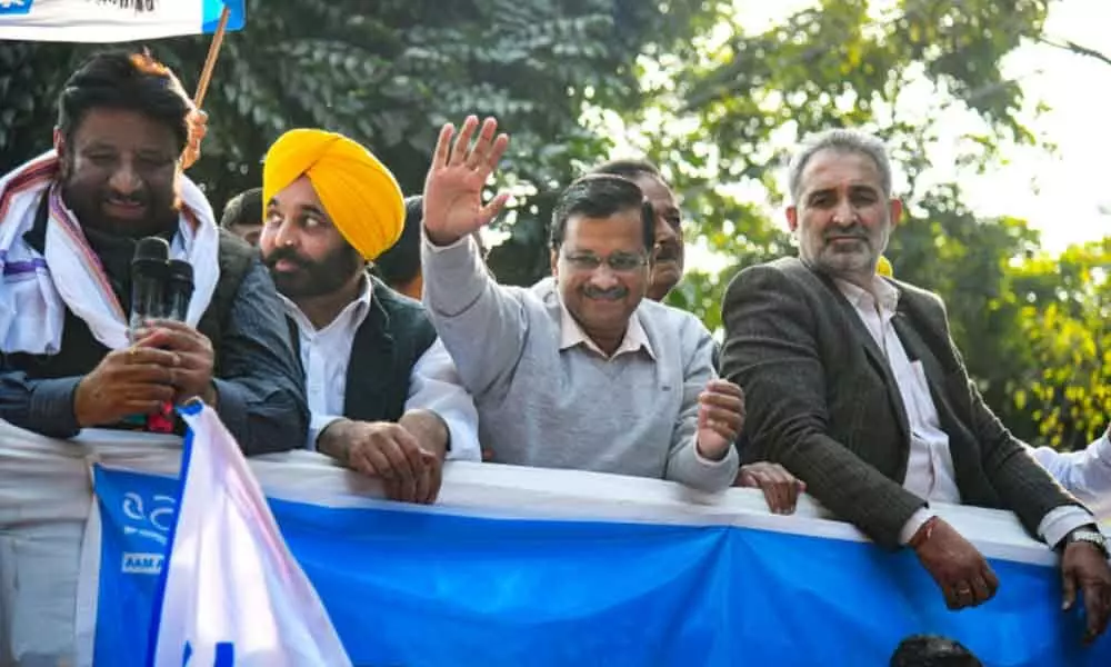 AAP convenor Arvind Kejriwal and party MP Bhagwant Mann during a thanksgiving rally organised after good performance of the the party candidates in municipal elections, in Chandigarh, Thursday, Dec 30, 201