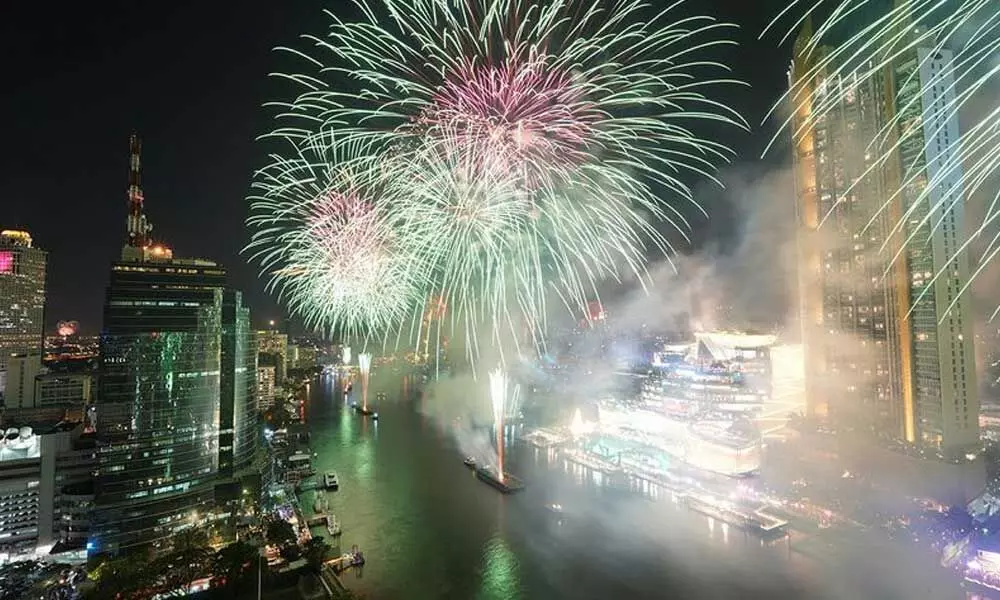 Fireworks explode over the Chao Phraya River during the New Year celebrations, amid the spread of the coronavirus disease (COVID-19) in Bangkok, Thailand.