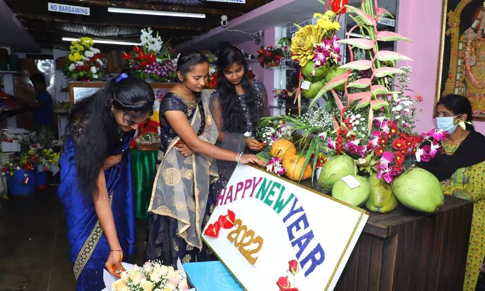 Students purchasing flower bouquets on the eve of New Year at a shop in Tirupati on Friday (Photo: Kalakata Radhakrishna)