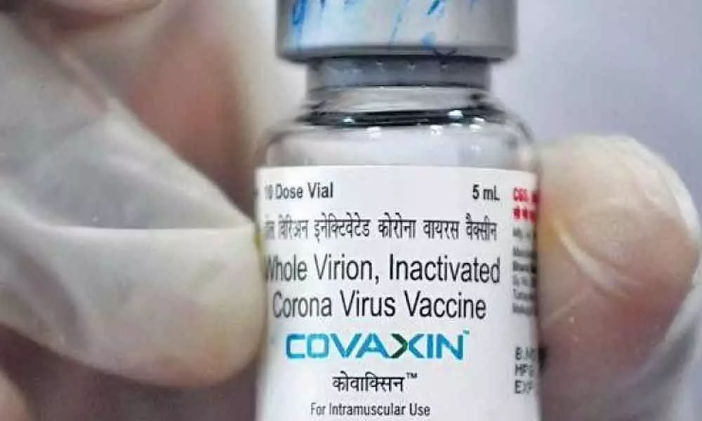 A vial of the Covaxin vaccine is being displayed by a medical worker. (File photo | AFP)