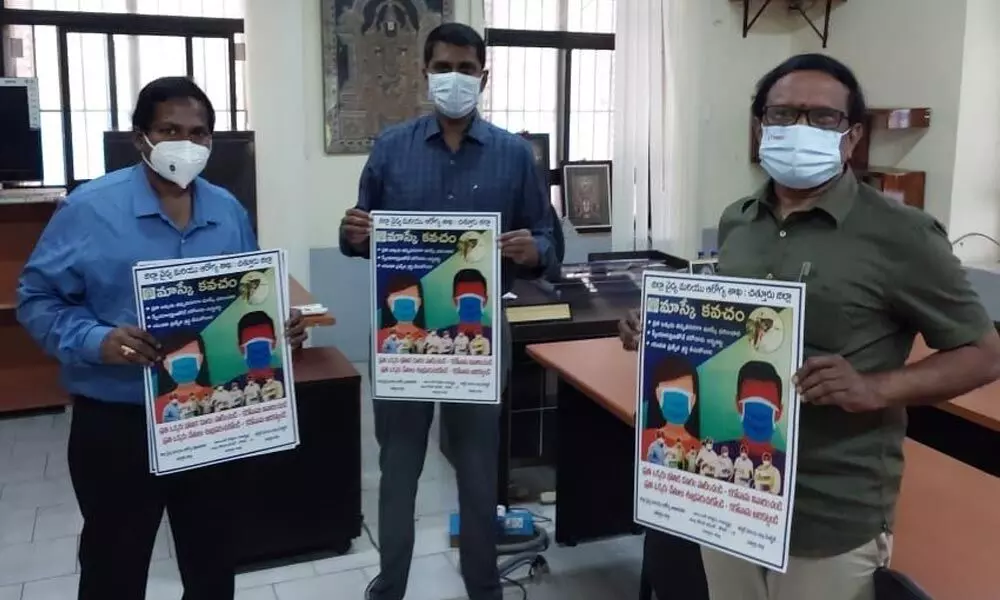 District Collector M Hari Narayanan, DM&HO Dr U Sreehari and Additional DM&HO Dr M Penchalaiah releasing Covid awareness posters in Chittoor