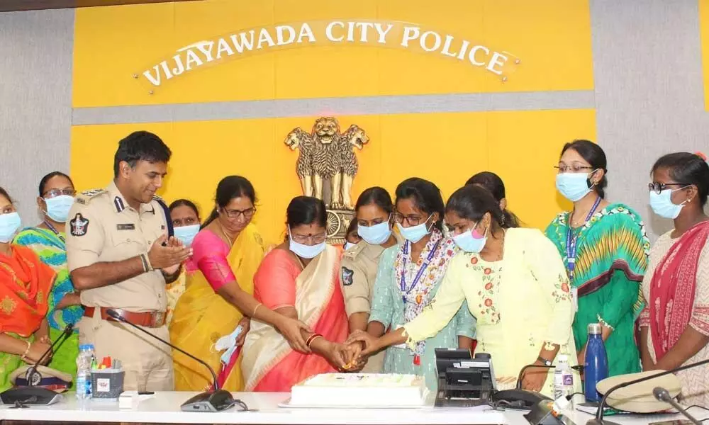 Commissione of Police Kanti Rana Tata and Mahila police and Mahila Mitra members cutting a cake at city police office in Vijayawada on Sunday