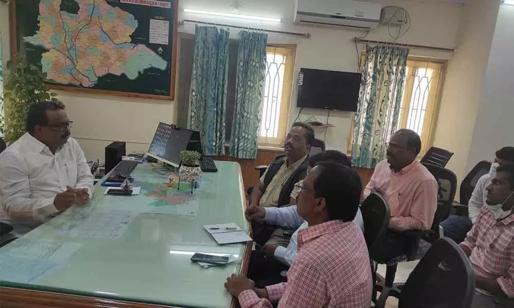 Collector S Venkat Rao holding a meeting with Transco officials at his camp office in Mahbubnagar on Monday