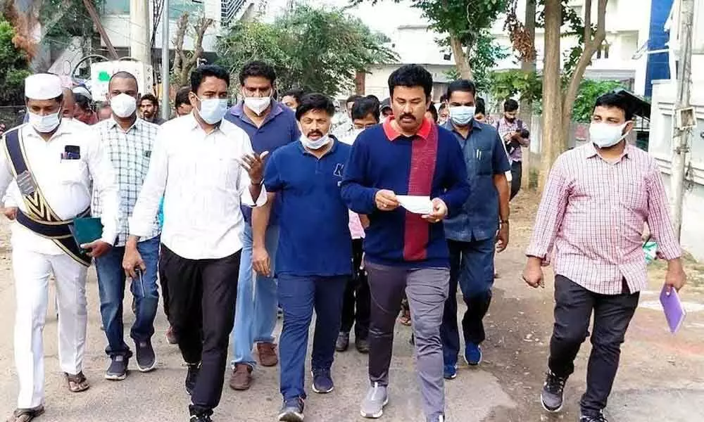 GVMC Commissioner G Lakshmisha, North Visakhapatnam constituency coordinator KK Raju and other officials at a colony as a part of the ward visit in Visakhapatnam on Monday