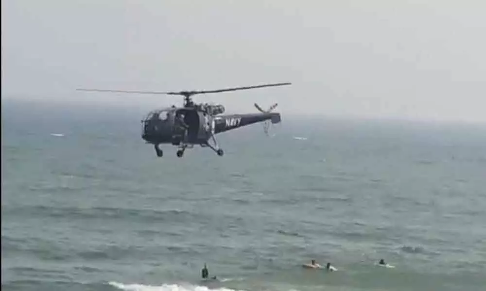 Indian Navy pressed in helicopter for a search operation at RK Beach in Visakhapatnam to recover bodies, on Monday