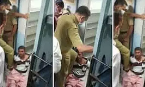 Still from the video captured by a co-passenger showing the ASI thrashing the passenger.