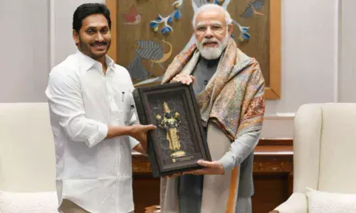 PM Narendra Modi receives a memento from Chief Minister Y S Jagan Mohan Reddy during their meeting in New Delhi on Monday