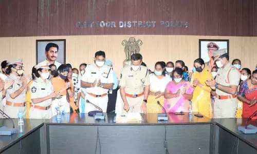 DIG  S Senthil Kumar cutting cake for 10 lakh women and girl students downloading Disha app in their mobile phones, in Chittoor on Monday