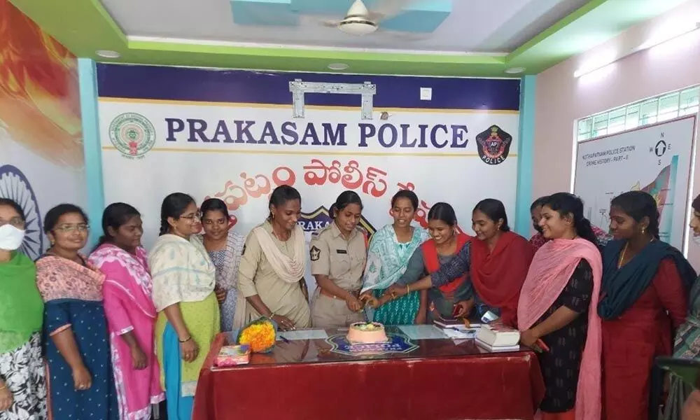 Women police cutting a cake as part of New Year celebrations at Kothapatnam police station on Tuesday
