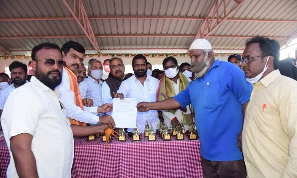 Sports Excise and Prohibition Minister Srinivas Goud handing over a CMRF cheque to a beneficiariy at the inauguration of a cricket tournament at Government Boys Jr College in Mahbubangar on Thursday