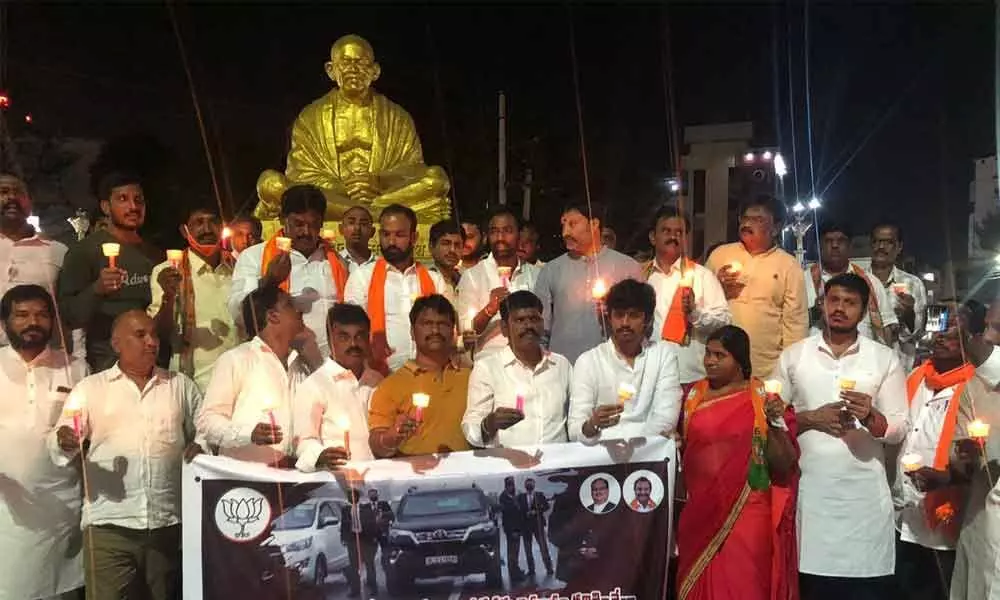 BJP and BJYM leaders taking a candle light rally protesting security breach during Prime Minister Narendra Modi visit to Punjab, at Gandhi statue in Tirupati on Thursday
