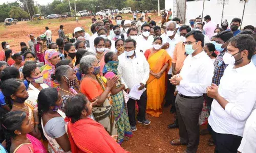 District Collector K V N Chakradhar Babu interacting with the housing beneficiaries at Mannarpoluru in Nellore on Thursday
