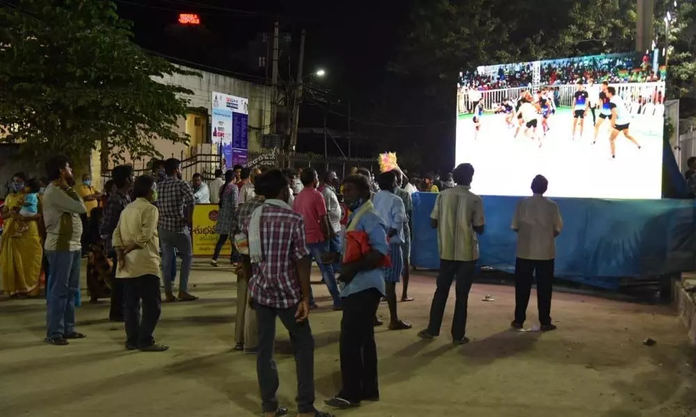 People watching a league match on digital TV at Indira Maidanam during the ongoing national invitation kabaddi tournament in Tirupati on Saturday