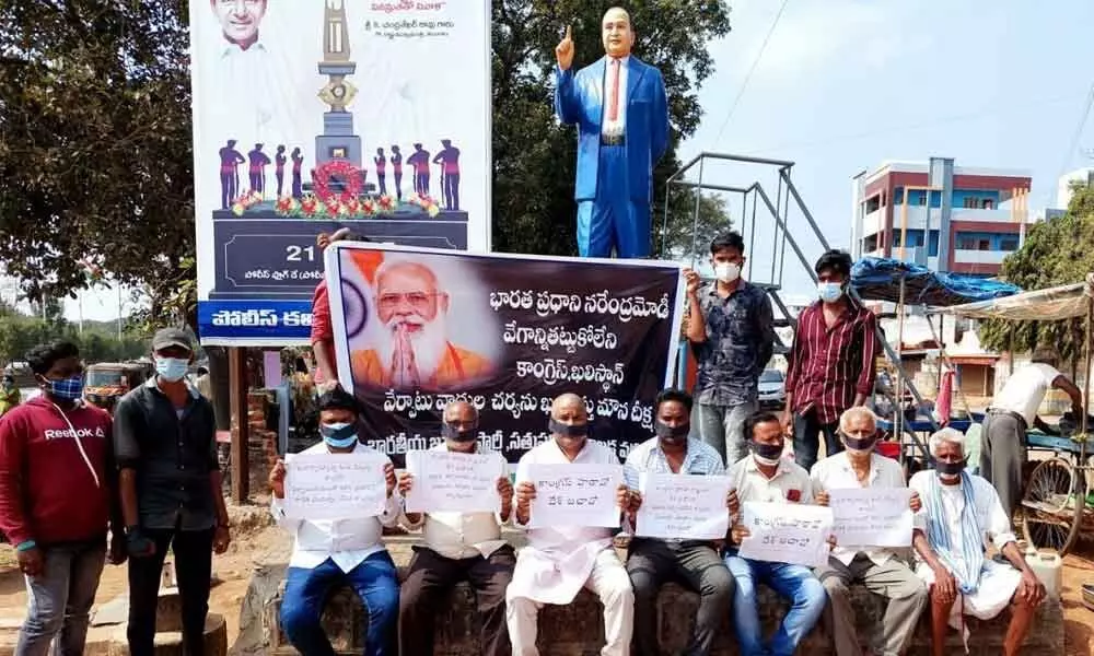 BJP leaders conducting silent protest wearing black ribbons before the Ambedkar Statue at Sathupalli on Monday