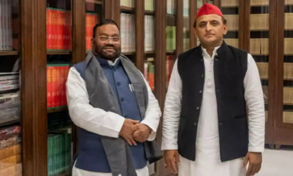 UP minister Swami Prasad Maurya (left) joins Samajwadi Party in the presence of the party chief Akhilesh Yadav, in Lucknow on Tuesday