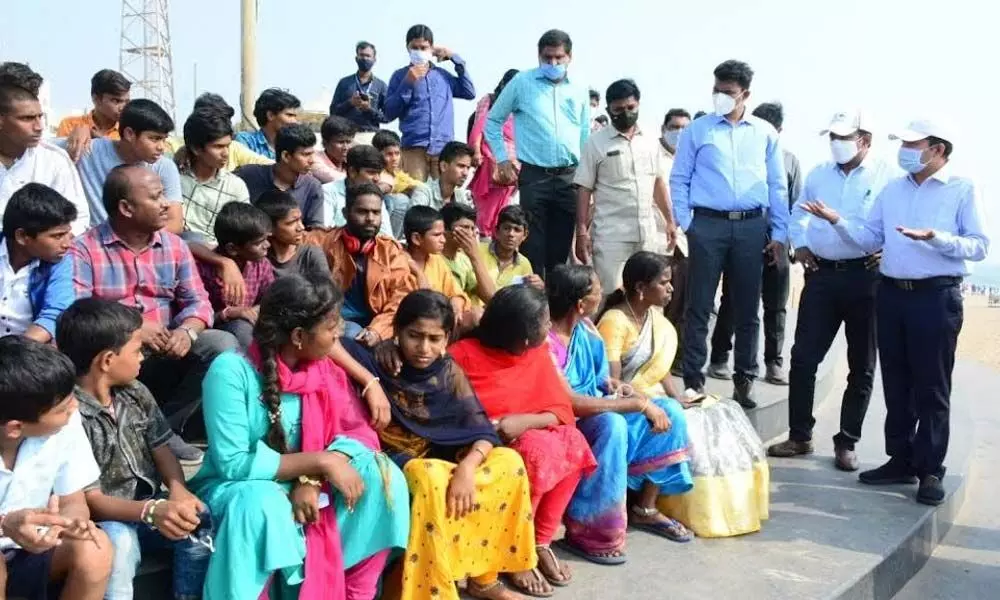 District Collector A Mallikarjuna creating awareness among tourists at Beach Road during his recent visit in Visakhapatnam