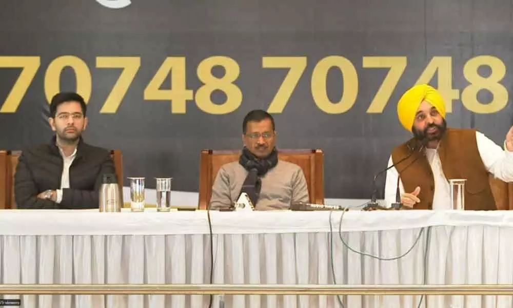Delhi CM and AAP convenor Arvind Kejriwal along with party leaders Bhagwant Mann (right) and Raghav Chadha addresses a press conference in Chandigarh on Thursday