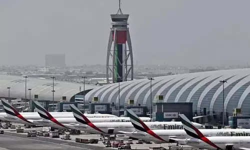 Emirates planes are parked at the Dubai International Airport.