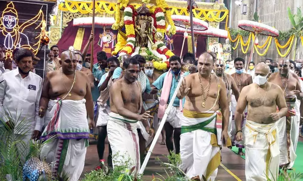 Priests performing mock hunt to mark the Paruveta Utsavam in Tirumala temple on Sunday. Additional EO A V Dharma Reddy is also seen.