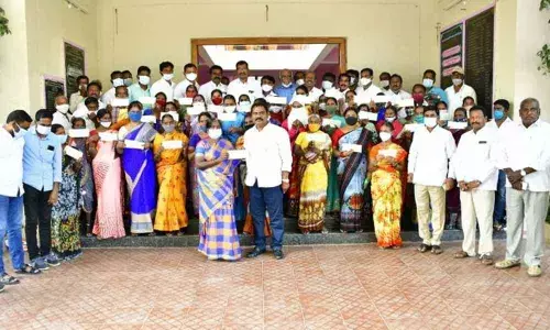 MLA Sunke Ravi Shankar handing over Kalyana Lakshmi cheques to beneficiaries at Gangadhar in Karimnagar district on Monday