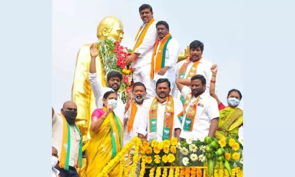 BJP district party president Galla Satyanrayana garlanding the statue of former CM NTR in Khammam on Tuesday