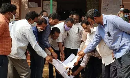 Employees burning the PRC GO copies at Government ITI, Tirupati on Tuesday
