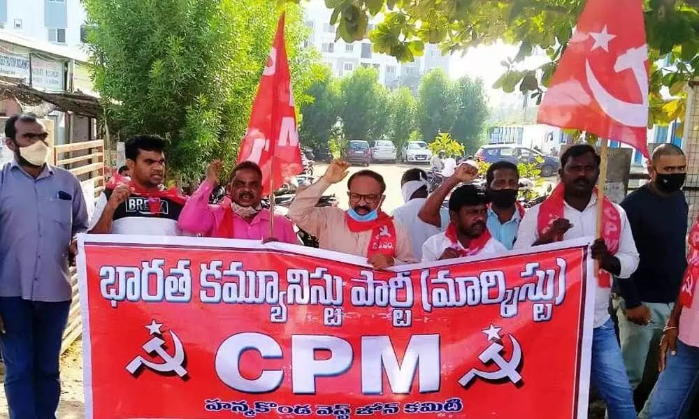 CPM workers staging protest against  private chit fund companies in Warangal on Thursday
