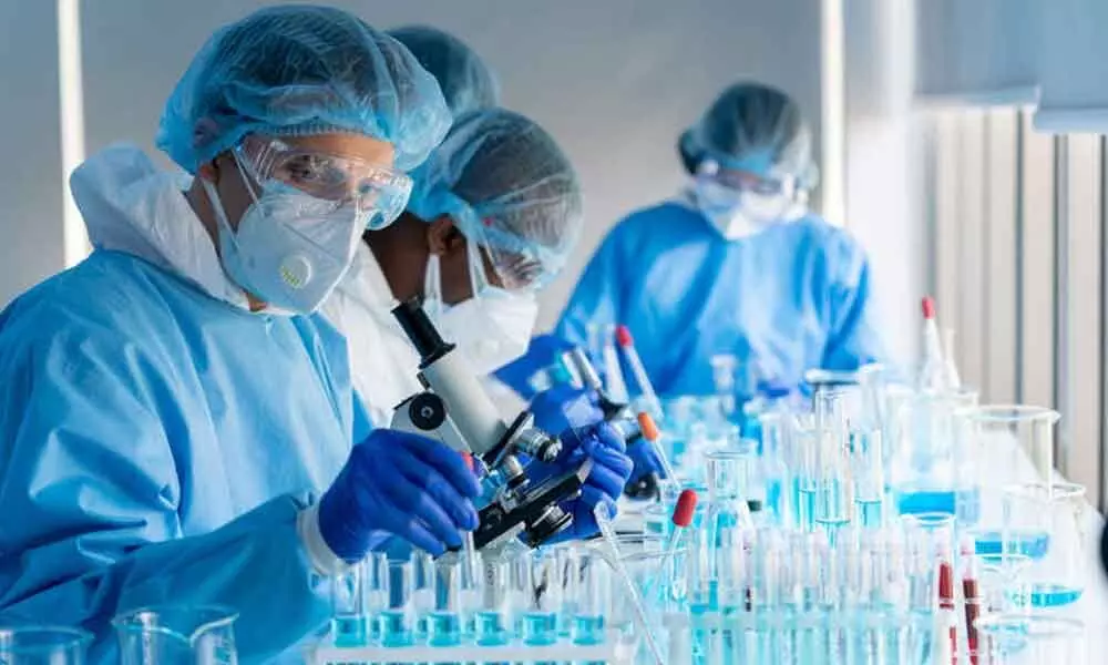 A stock photo shows researchers working in a laboratory. BA.2 is increasing in proportion to BA.1 in a number of countries.