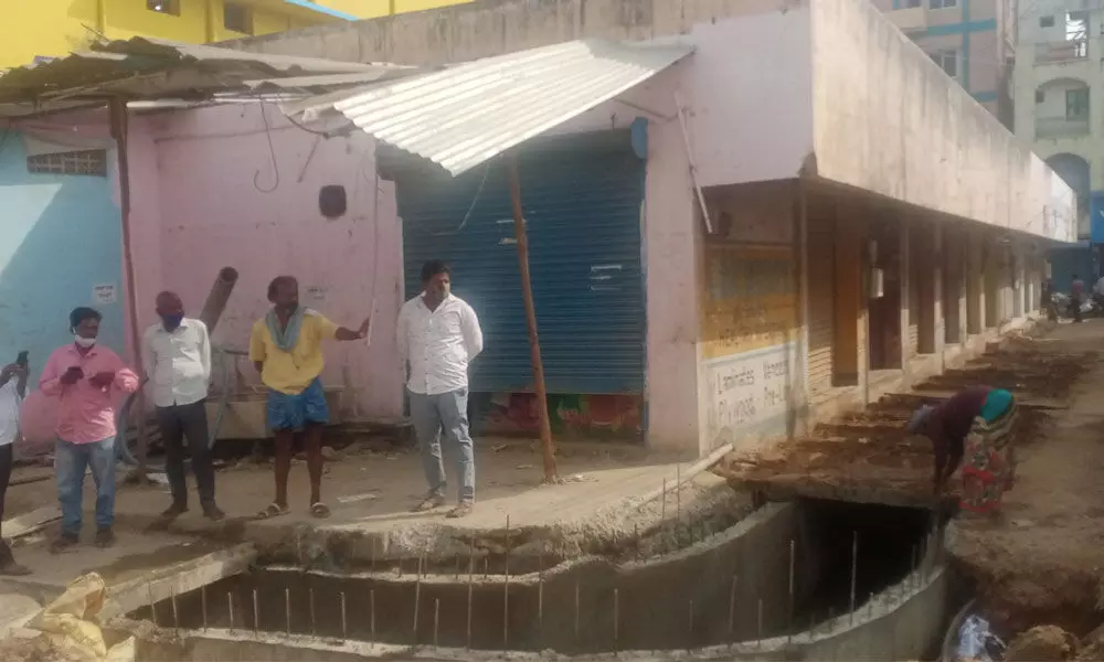 Widening and deepening of drains progressing at Mahduranagar in Tirupati.