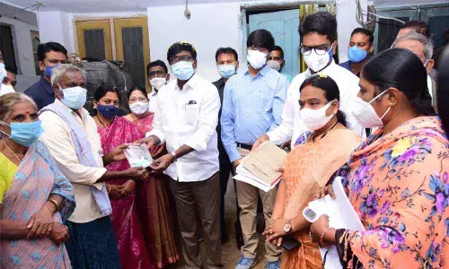 Minister for Transport Puvvada Ajay Kumar distributing Kits to people during the fever survey programme at Khammam town on Tuesday