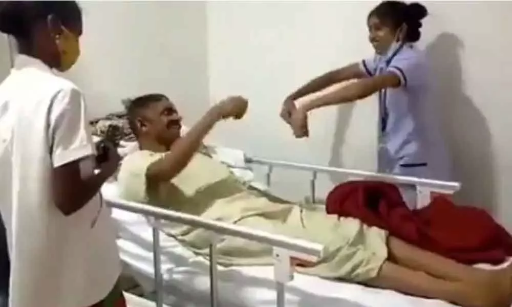 Nurse Dancing To Cheer Up Paralysis Patient During Physiotherapy Session