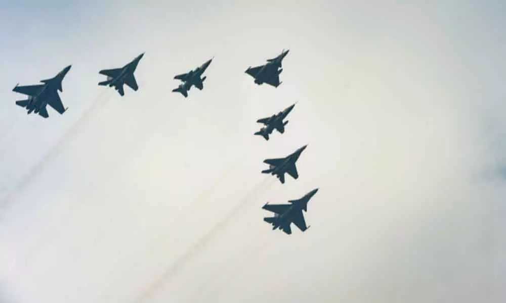 Indian Air Force (IAF) fighter jets flypast during the Republic Day Parade 2022 in New Delhi on Wednesday.(Right) IAF Sarang (ALH) flypast in Ladder formation