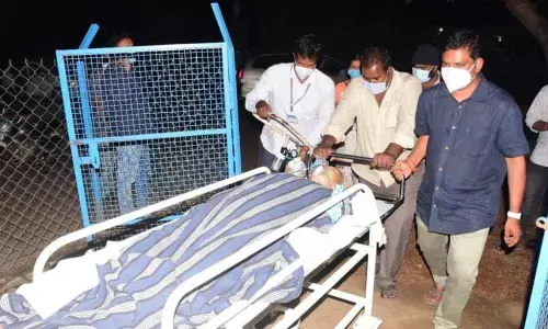 Ruia HDS working chairman Bandla Chandrasekhar and his team taking a patient on oxygen support for scanning as no stretcher boys are available