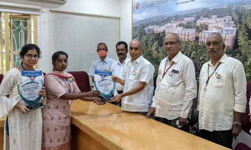 SRKR Engineering College students receiving Origanti Sundari Meritorious Award from college secretary and correspondent Sagi Vithal Ranga Raju in the college in Bhimavaram on Friday