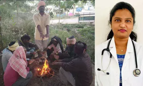 People sitting before bonfire; Dr Shreeja