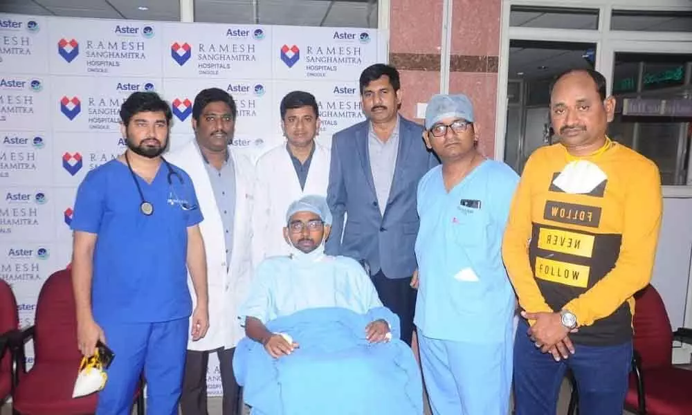 Patient and his father along with the team of expert doctors, who treated him, at Ramesh Sanghamitra Hospital in Ongole on Monday