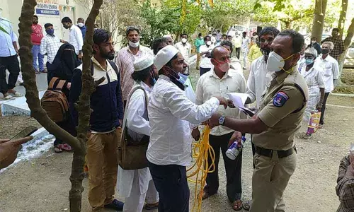 Police officials taking the man into custody for allegedly trying to end his life in front of the Collector office on Monday